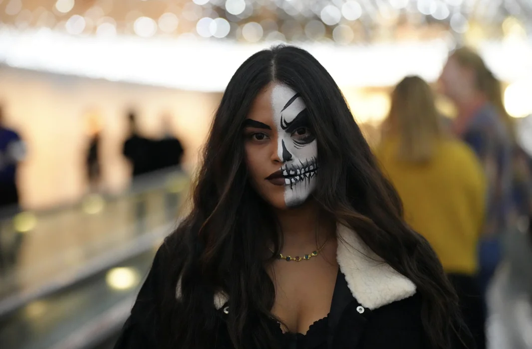 A guest in half-skull face paint at National Gallery Nights in the East Building